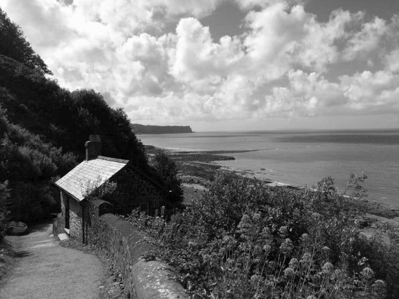 A lone bricked hut looking over the sea