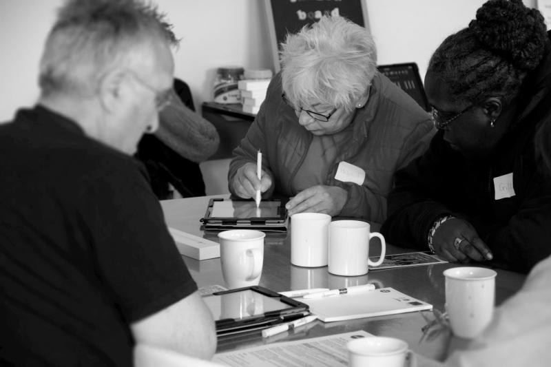 Participants interacting with tablets in a technology workshop