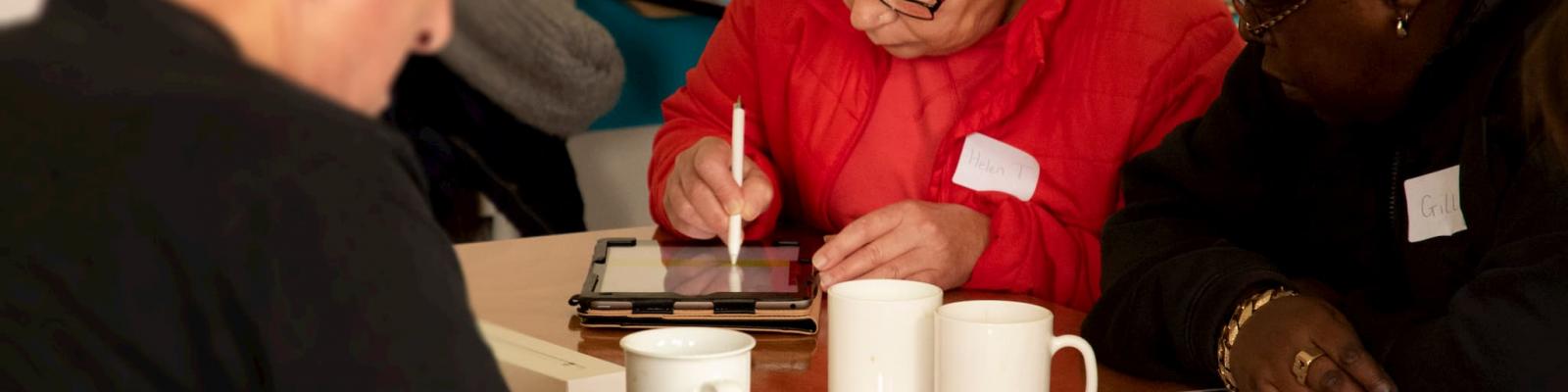 Participants interacting with tablets in a technology workshop